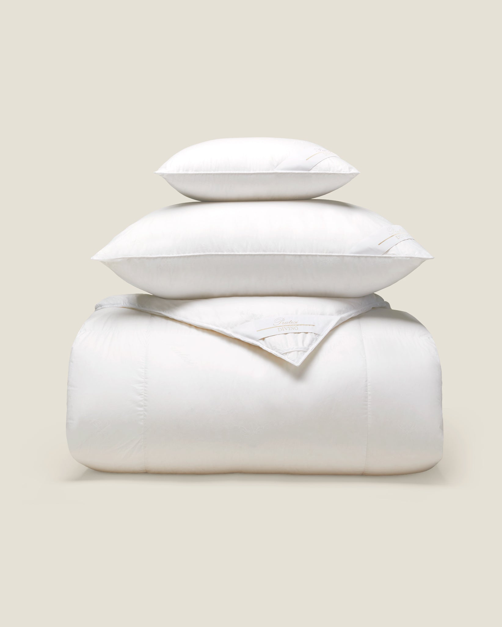 stack of white goose down pillows and duvet
