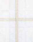 swatch of a white quiltino with beige embroidery