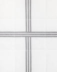 swatch of a white quiltino with charcoal embroidery