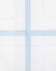 swatch of a white quiltino with light blue embroidery