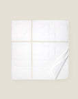 white quiltino with beige embroidery