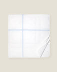 white quiltino with light blue embroidery