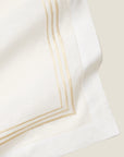 close up white linen table runner with beige embroidery