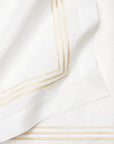 Close-up of a white fabric with beige stripes embroidery