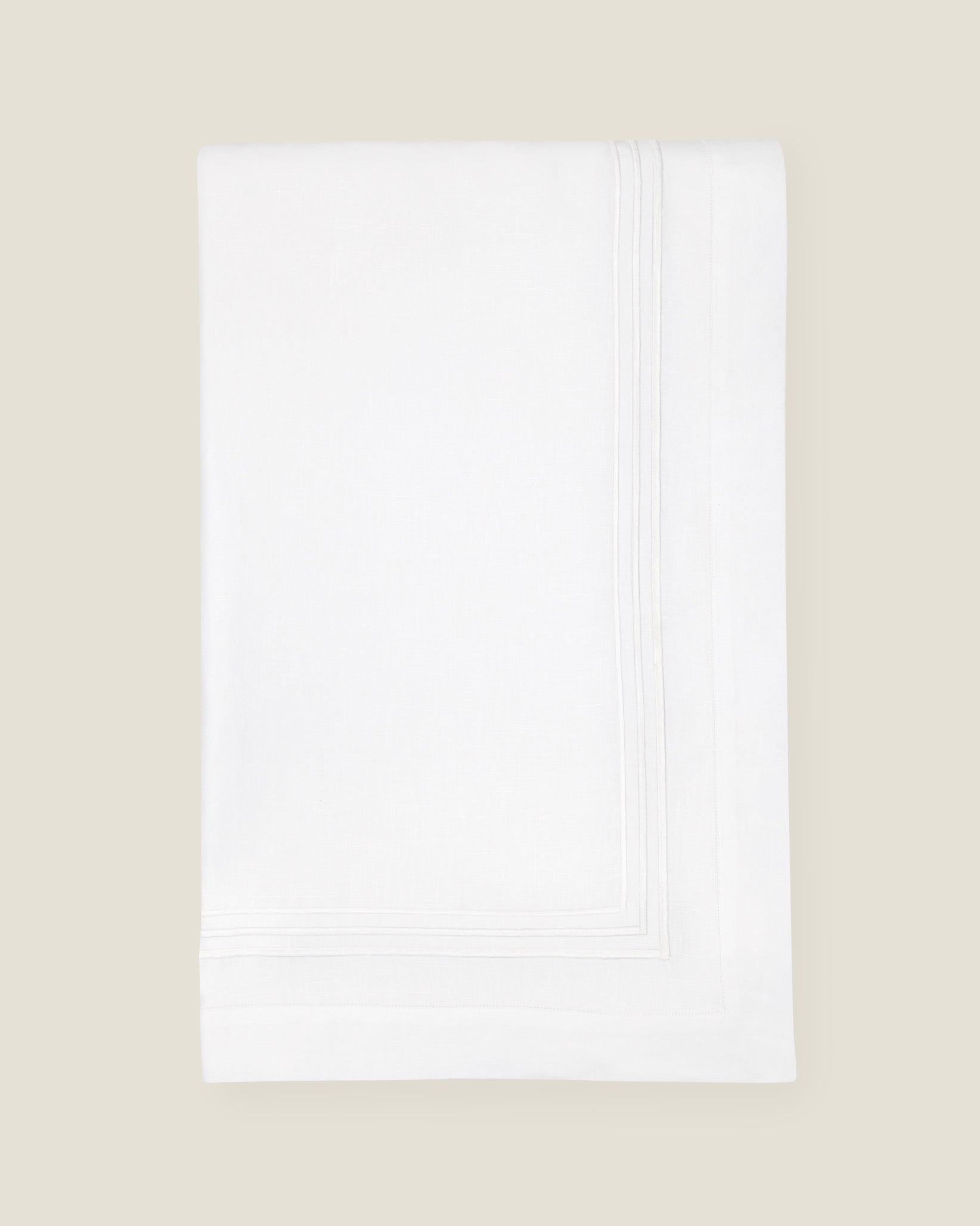 folded white tablecloth with white stripes embroidery