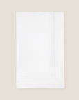 folded white tablecloth with white stripes embroidery