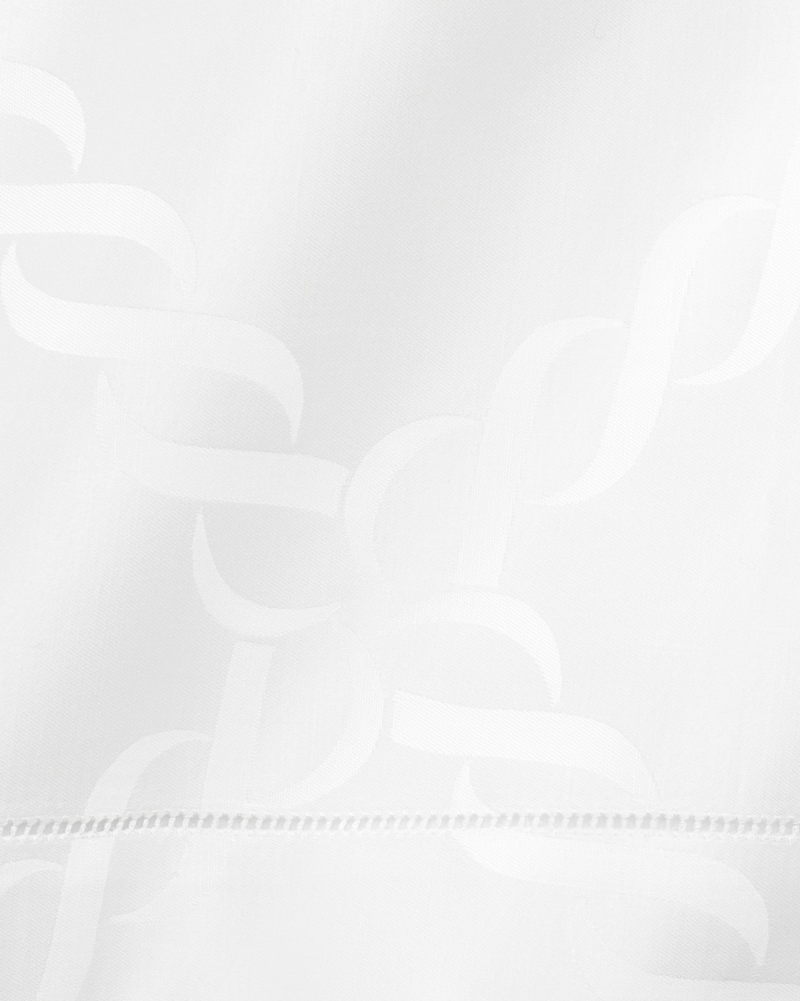 close up white tablecloth with braid motif pattern