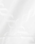 close up white tablecloth with braid motif pattern