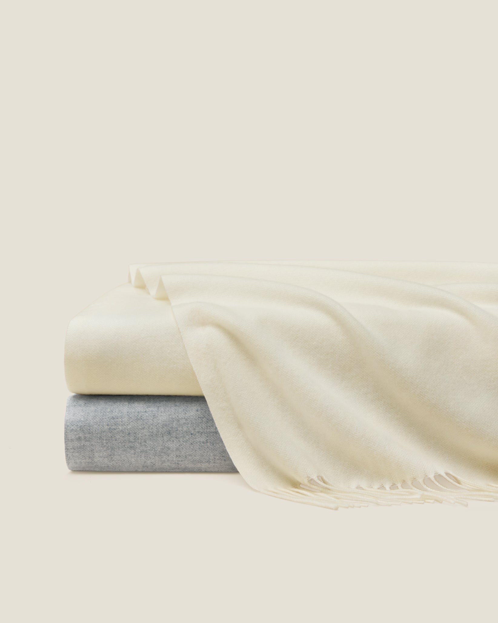 Misurina throws stacked in ivory and grey