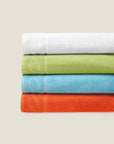 Treccia beach towel stack in white, lime, caribbean, and ocean