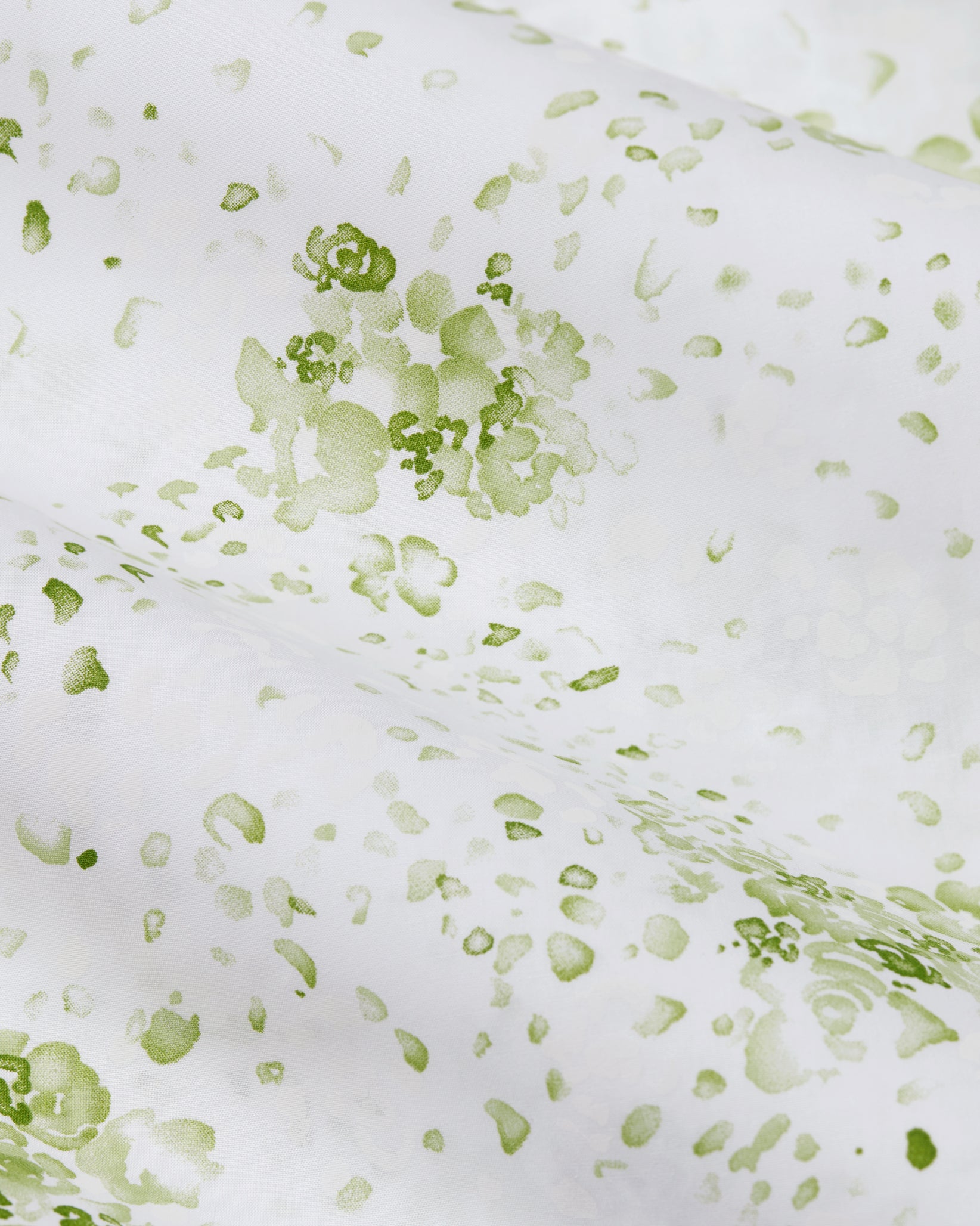 Green floral pattern on a white background