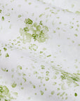 Green floral pattern on a white background