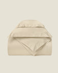 Splendore beige duvet cover and shams stacked.
