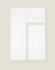 Tre Righe flat sheet white/sage folded.