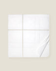 white quiltino with sage embroidery