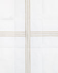swatch of a white quiltino with sage embroidery