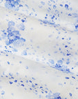 White fabric with blue watercolor-like speckles