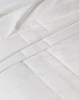 close up view of a quiltino on a bed