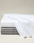 Raso Rigato flat sheet in white and charcoal stacked
