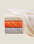 Marca Throws in ivory, orange & sterling stacked