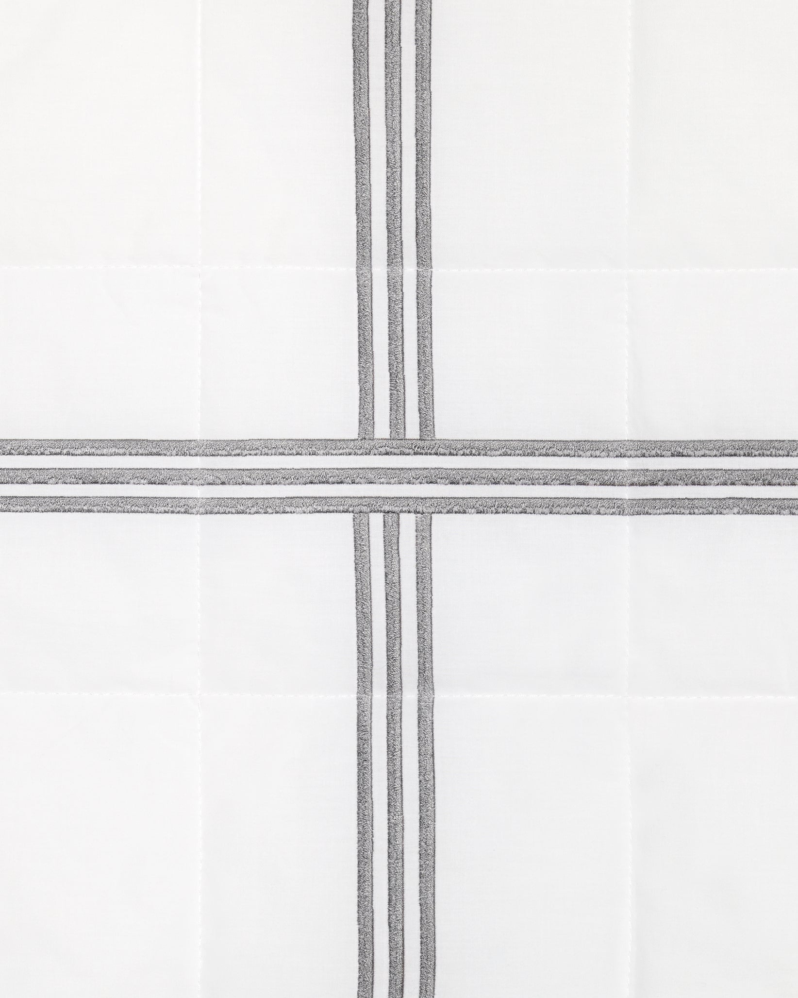 swatch of a white quiltino with charcoal embroidery