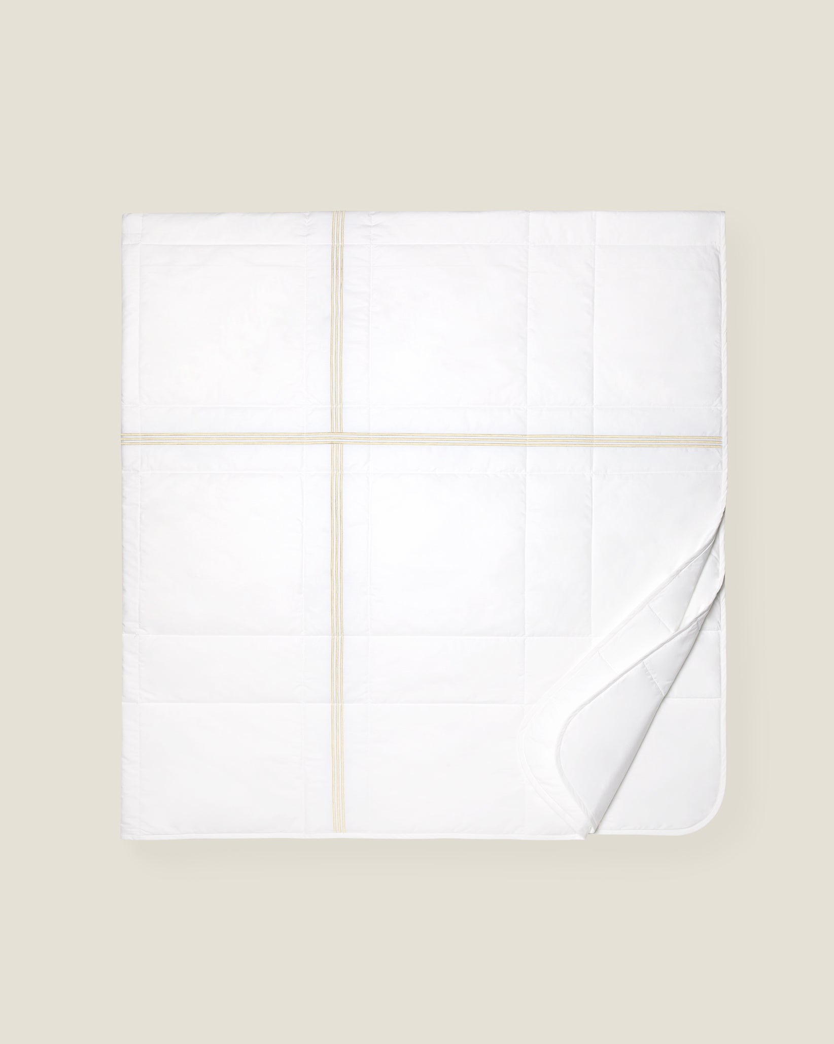 white quiltino with beige embroidery
