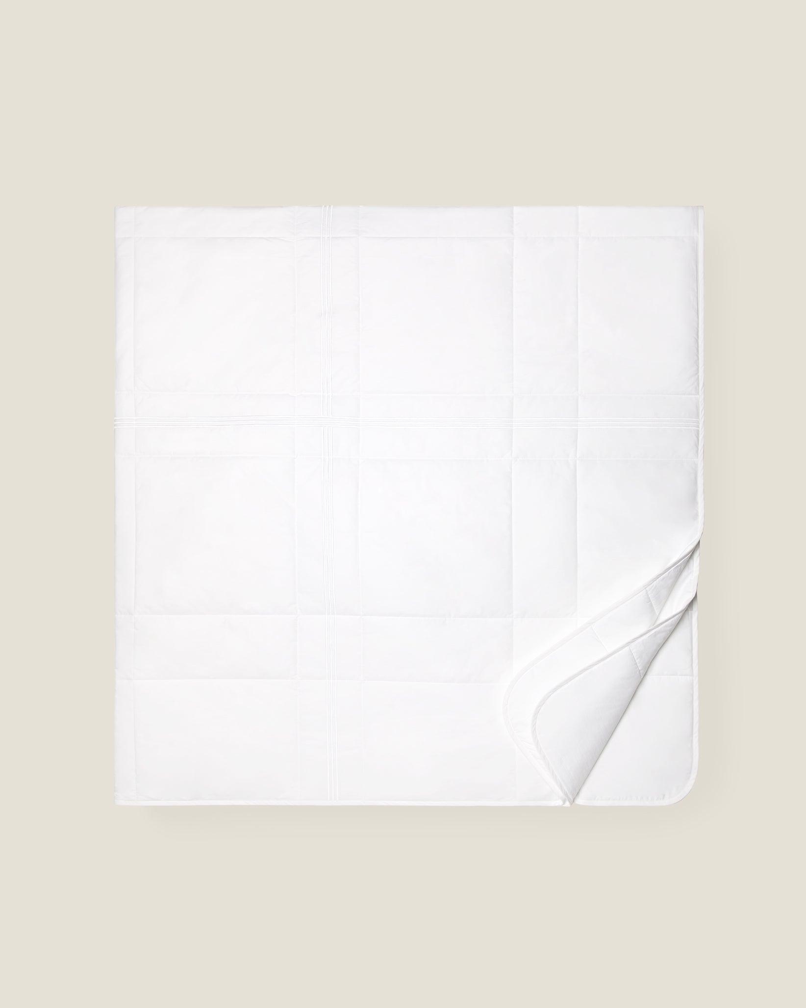 white quiltino with white embroidery