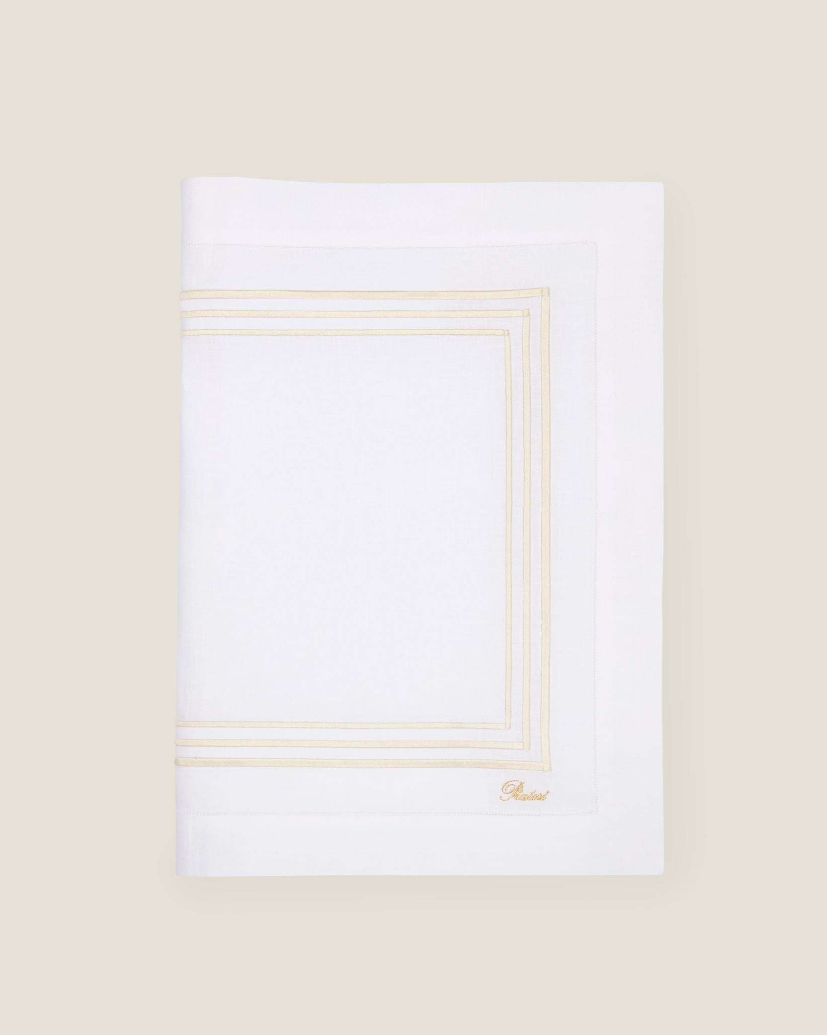 folded white linen table runner with beige stripes embroidery