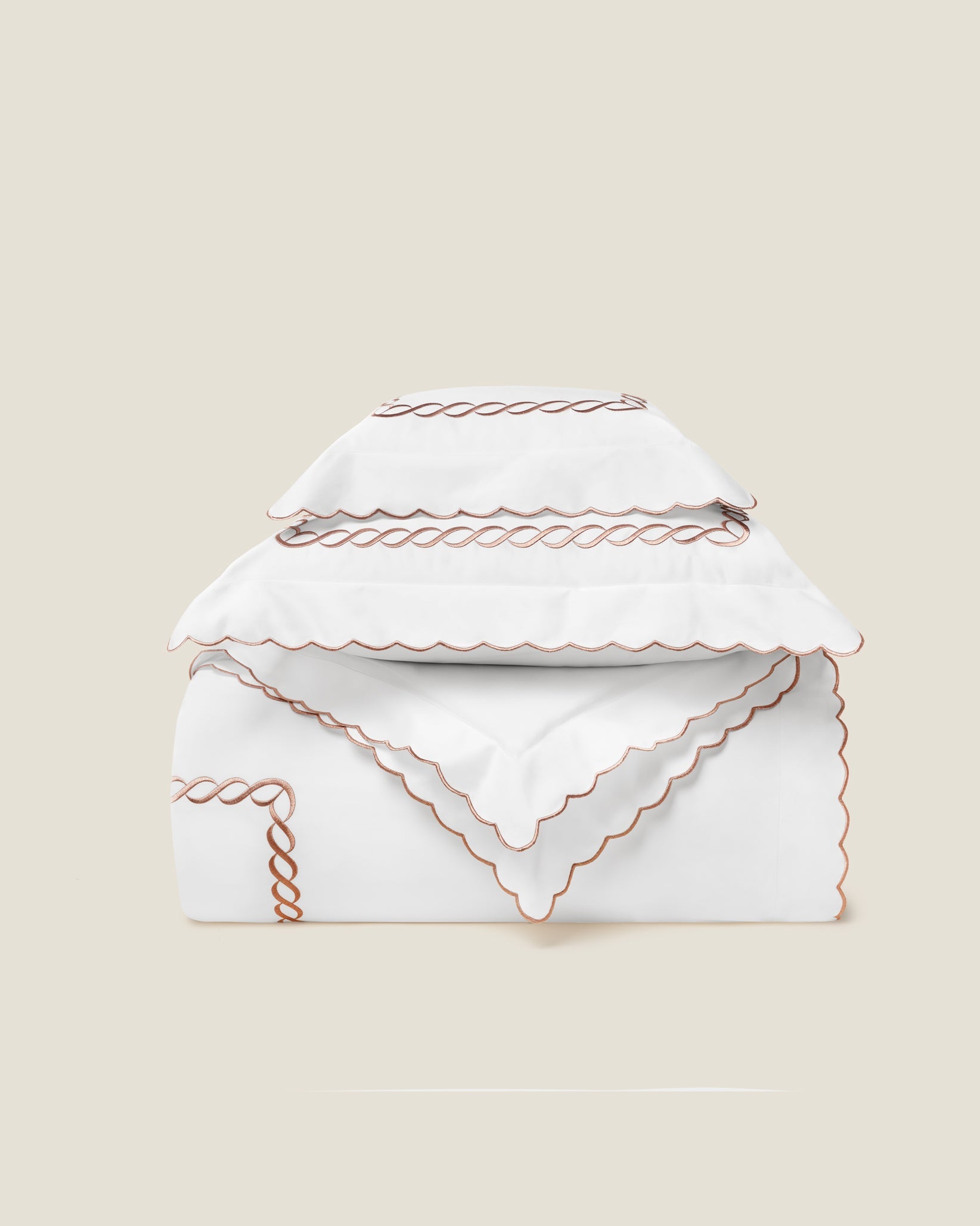 Treccia Splendore duvet cover stack in white/rose gold