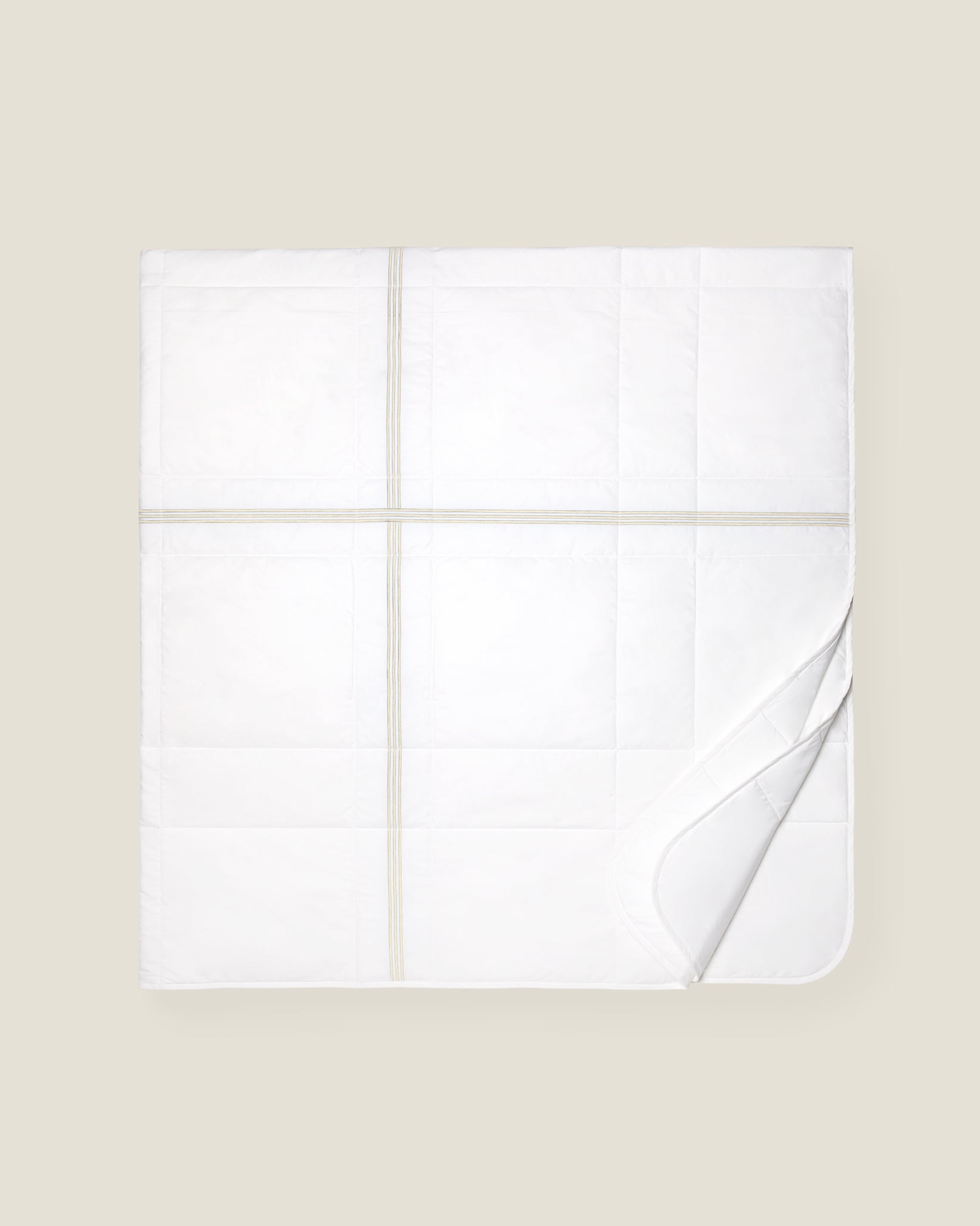 white quiltino with sage embroidery