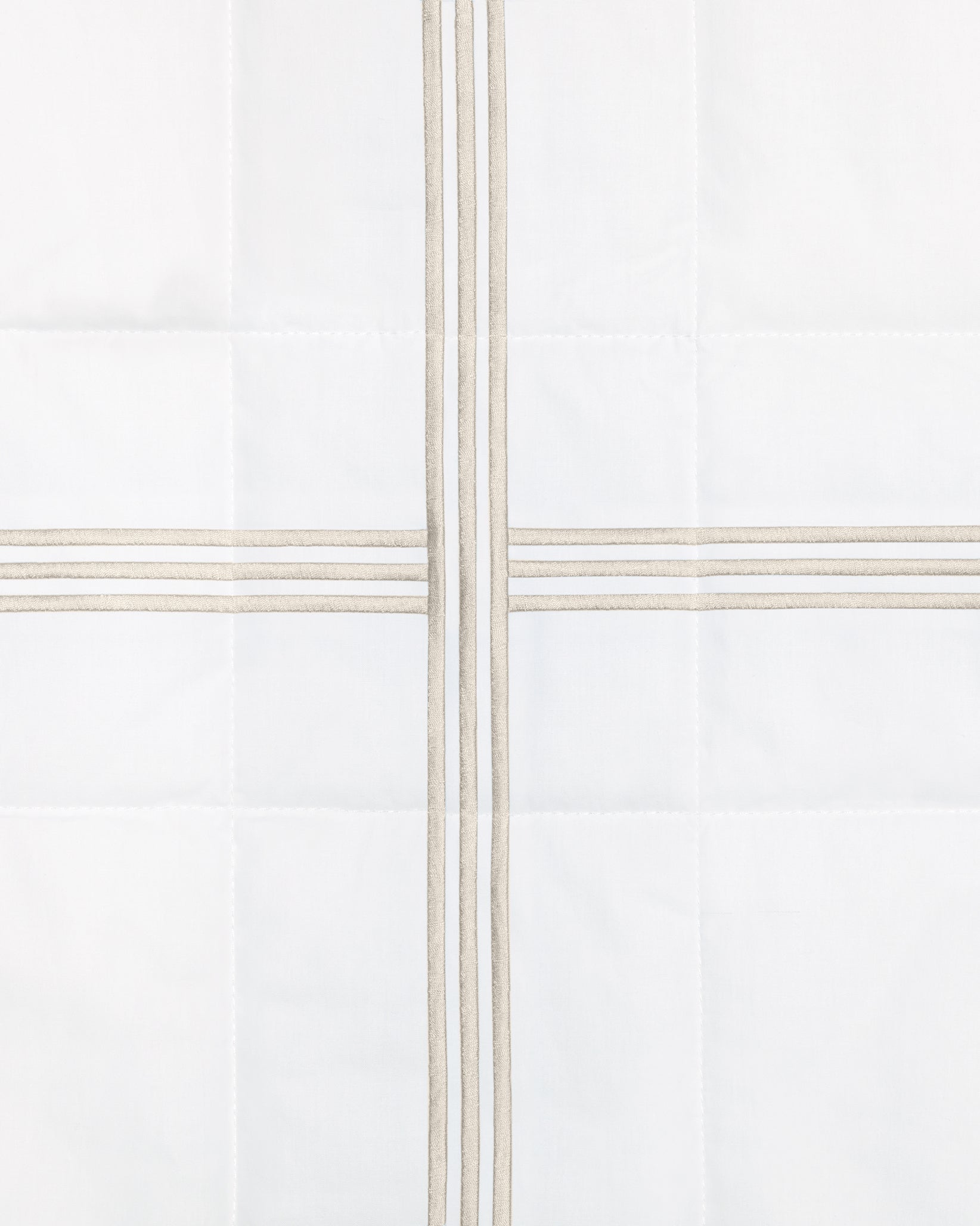 swatch of a white quiltino with sage embroidery
