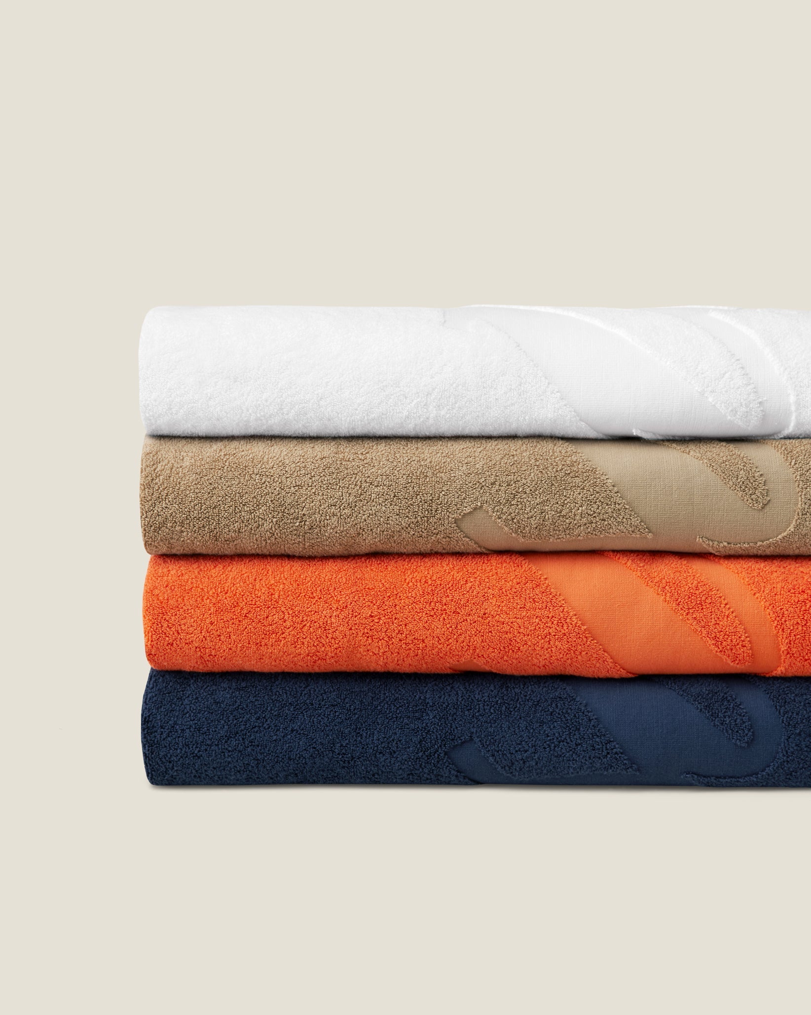 Pratesi beach towel stack white, beige, orange and navy