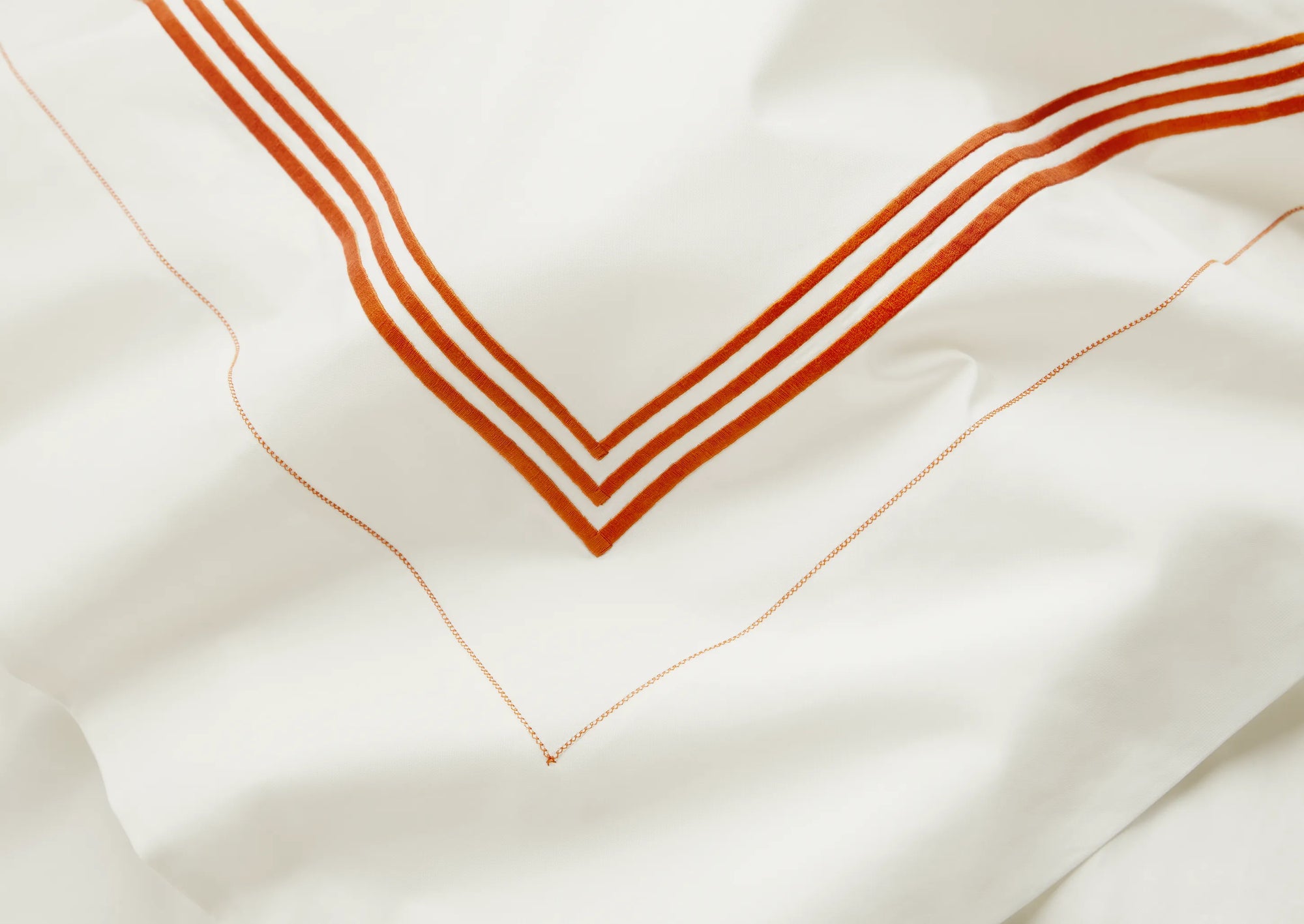 Tre Righe Ivory/orange bed linens close up
