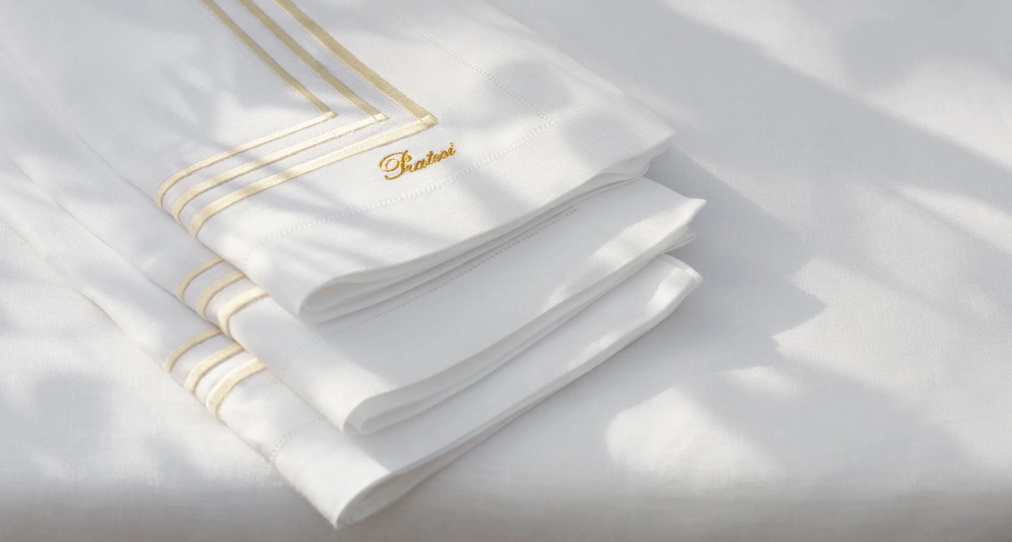 Tre Righe white.beige napkins stacked on the tablecloth