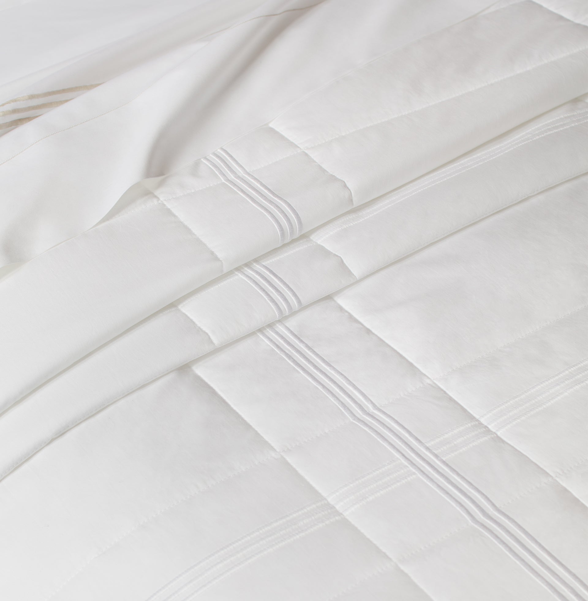 close up view of a quiltino on a bed